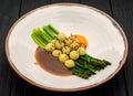 Asparagus with baby potatoes, with meat sauce and egg yolk Royalty Free Stock Photo