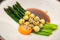 Asparagus with baby potatoes, with meat sauce and egg yolk Royalty Free Stock Photo