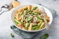 Asparagus and bacon penne pasta with parmesan cheese in white bowl Royalty Free Stock Photo