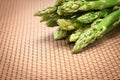 Asparagus bind with brown ribbon on brown wickerwork background Royalty Free Stock Photo