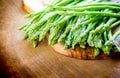 Asparagus, a bunch of fresh asparagus, on a wooden cutting board made of olive wood Royalty Free Stock Photo