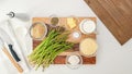 Asparagus casserole recipe. Fresh green asparagus and some ingredients close up on wooden board Royalty Free Stock Photo