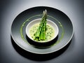 Asparagus cream soup and asparagus on a white plate