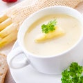 Asparagus cream soup with capers and fresh baguette Royalty Free Stock Photo