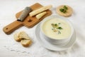 Asparagus cream soup with parsley garnish in a bowl and a wooden Royalty Free Stock Photo