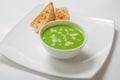 Asparagus cream soup in white bowl with bread Royalty Free Stock Photo