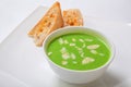 Asparagus cream soup in white bowl with bread Royalty Free Stock Photo