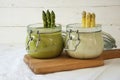Asparagus cream soup white and green creatively served in glass