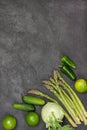 Asparagus, cucumbers, lime and kohlrabi on table