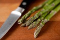 Asparagus on cutting board with knife