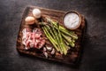 Asparagus eggs bacon and garlic on butcher board. - top of view Royalty Free Stock Photo