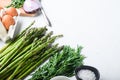 Asparagus eggs and french dressing ingredients with dijon mustard, onion chopped in red vinegar  taragon on white textured Royalty Free Stock Photo