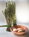 Asparagus and eggs on white background