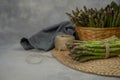 Asparagus. Fresh raw organic green Asparagus sprouts closeup. Basket and bunch n the table. Healthy vegetarian food. Raw