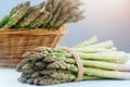 Asparagus. Fresh raw organic green Asparagus sprouts closeup. Basket and bunch n the table. Healthy vegetarian food