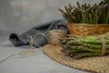 Asparagus. Fresh raw organic green Asparagus sprouts closeup. Basket and bunch n the table. Healthy vegetarian food. Raw