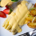 Asparagus , hollandaise sauce and baked potatoes