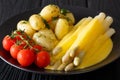 Asparagus with hollandaise sauce, new potatoes, greens and fresh Royalty Free Stock Photo