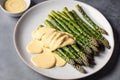 Asparagus with hollandaise sauce on a white plate, closeup. Healthy food concept. Generative AI