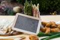 Asparagus, potatoes, empty blackboard Royalty Free Stock Photo