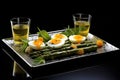 asparagus and quail eggs garnished on a rectangular glass plate