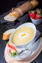 Asparagus soup with poached egg and fresh baguettes