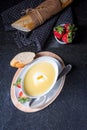 Asparagus soup with poached egg and fresh baguettes