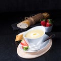 Asparagus soup with poached egg and fresh baguettes