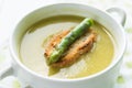 Asparagus soup in a white bowl with slice of bread and asparagus Royalty Free Stock Photo