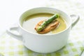 Asparagus soup in a white bowl with slice of bread and asparagus Royalty Free Stock Photo