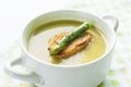 Asparagus soup in a white bowl with slice of bread and asparagus Royalty Free Stock Photo