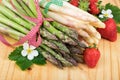 Asparagus with strawberries on wood. Vegan food, vegetarian and healthy cooking concept. Royalty Free Stock Photo