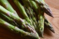 Closeup of Asparagus tips on a wooden cutting board Royalty Free Stock Photo