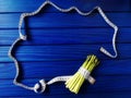 asparagus wrapped with measuring tape on blue wooden background