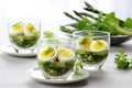 asparagus wrapped with organic quail egg salad in glass bowls