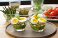 asparagus wrapped with organic quail egg salad in glass bowls