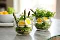 asparagus wrapped with organic quail egg salad in glass bowls