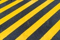 Asphalt Background with diagonal black and yellow warning stripe