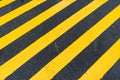 Asphalt Background with diagonal black and yellow warning stripe