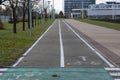 Asphalt bike path running along the paved sidewalk and separated by markings. Empty streets of an deserted city Royalty Free Stock Photo