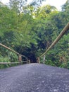 The asphalt bridge with a traditional wooden handholds at one of magelang village