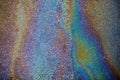 Asphalt covering with rainbow oil flows Royalty Free Stock Photo