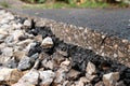 Asphalt is cut diagonal in the frame of rubble and road Royalty Free Stock Photo