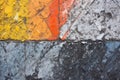 asphalt with dried paint splatters in various colors