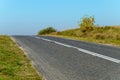 asphalt empty road and green grass. against the clear blue sky. autumn landscape Royalty Free Stock Photo