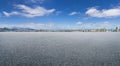 Asphalt floor with faraway cityscape background