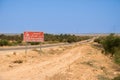 Asphalt highway in the desert with red sign of the passage of camels Royalty Free Stock Photo