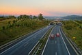 Asphalt highway with ecoduct at sunset Royalty Free Stock Photo