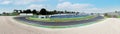 Asphalt motor sport circuit turn panoramic view of track and external gravel trap