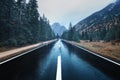 Asphalt mountain road in foggy forest in overcast rainy day Royalty Free Stock Photo